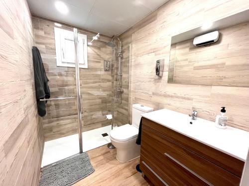 a bathroom with a shower and a toilet and a sink at Maximilian 3 in Madrid