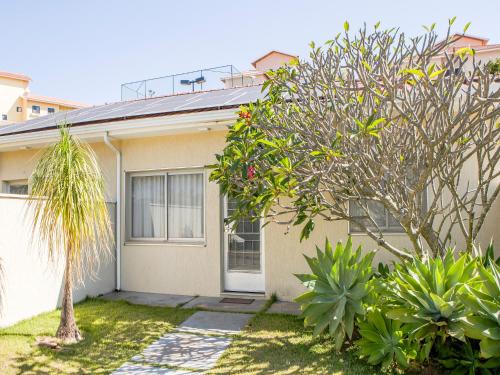 a house with trees and plants in front of it at Vinhedo Plaza Hotel in Vinhedo