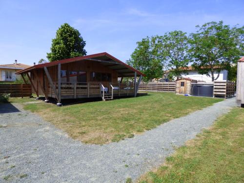 a house with a fence and a grass yard at Le Carbet Vendéen in Bouillé-Courdault