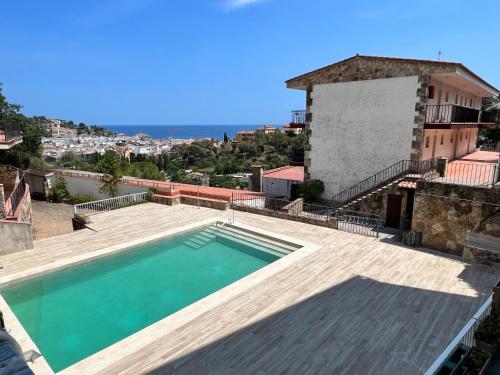 a swimming pool on the roof of a house at Sailor Apartment sea views in Tossa de Mar