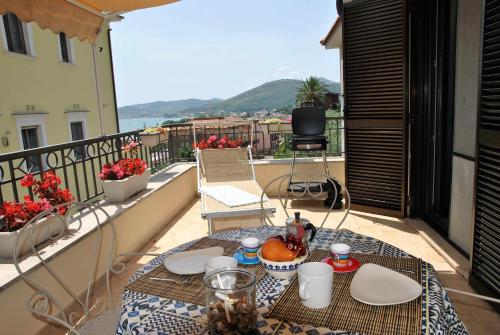 a table on a balcony with a view of the ocean at CASA DINKY Attico con terrazza vista mare in Formia