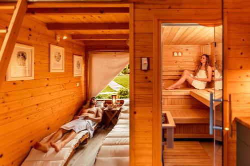 a sauna with two people laying in beds at Glamping Mountain Fairy Tale in Bistrica pri Tržiču