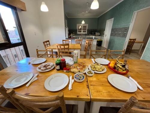 a wooden table with plates of food on it at Masaya Hurghada Rooms in Hurghada