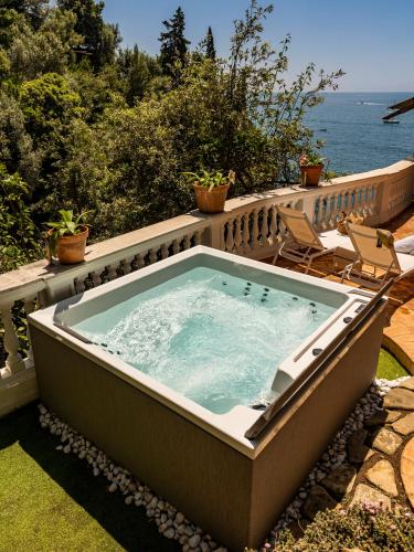 a jacuzzi tub on a patio next to the ocean at Villa Nannina in Positano