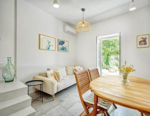 a living room with a table and a couch at House Gajarda in Rab