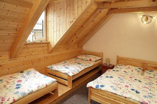 a room with two beds in a cabin at Penzion pod Březinkou in Polička