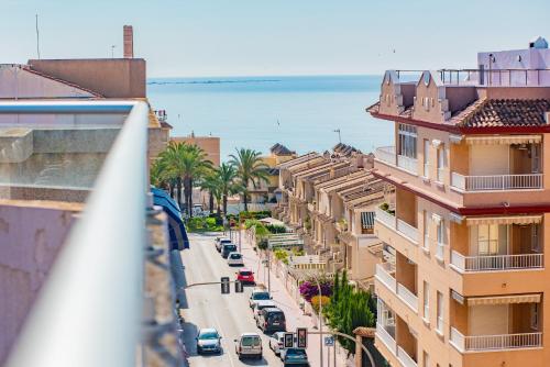 a view of a city street with buildings and the ocean at Hotel Eden Mar in Guardamar del Segura