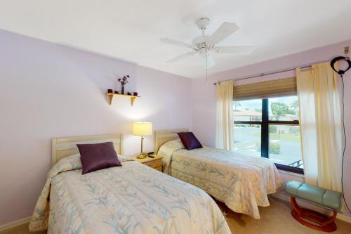 a bedroom with two beds and a window at Sea-Renity, Unit H-205 in Naples