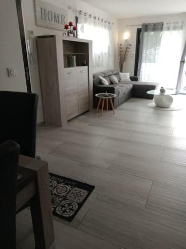 a living room with a couch and a living room with a floor at VILLA NOUNOU in Le Thor