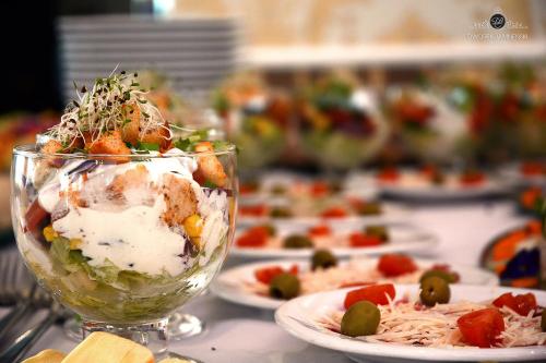 a table topped with plates of food with a dessert at Dworek Jamneński in Łazy