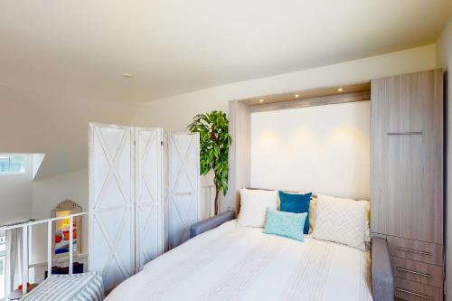 a bedroom with a large white bed with blue pillows at Remote Worker Paradise in Los Angeles