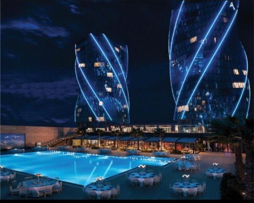 a large swimming pool in front of a large building at İstanbul Lüks daire in Istanbul