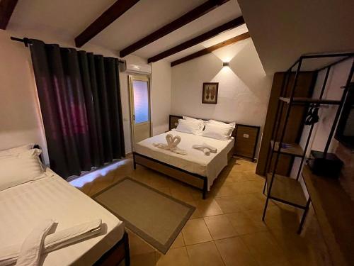 a small room with two beds and a ladder at Hotel Kappa3 Villas in Vlorë