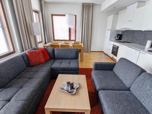 a living room with a couch and a table at Holiday Home Nordic chalet 9312 by Interhome in Ylläsjärvi