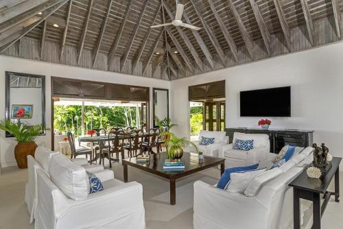 a living room with white couches and a table at Luxurious 5-bedroom cottage with Private Pool in Hopewell