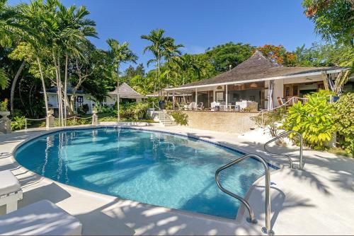 a swimming pool in front of a house at Luxurious 5-bedroom cottage with Private Pool in Hopewell