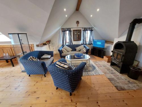 a living room with couches and a wood stove at Apartment Alte Post-3 by Interhome in Aggsbach