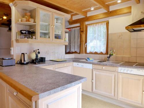 a kitchen with white cabinets and a counter top at Chalet Tschingeli by Interhome in Niedergampel