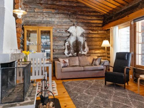 a living room with a couch and a fireplace at Holiday Home Sallan savu e by Interhome in Salla