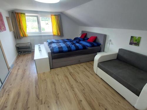 a bedroom with a bed and a couch at Apartment Garden-2 by Interhome in Karl