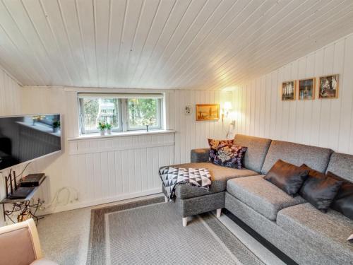 a living room with a couch and a window at Holiday Home Wimmer - 800m from the sea in Western Jutland by Interhome in Vejers Strand