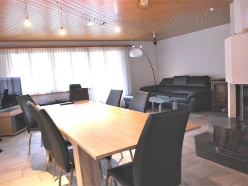 a conference room with a wooden table and chairs at Apartment Calanques by Interhome in Adelboden