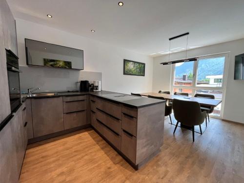 a kitchen with a table and a dining room at Apartment Apart Andrea by Interhome in Längenfeld
