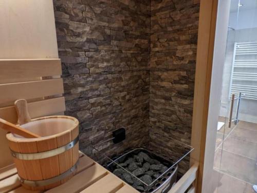a bathroom with a shower with a stone wall at Apartment Apart Andrea by Interhome in Längenfeld