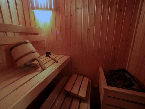 a wooden sauna with a bench and a tub at Holiday Home Mezná u Hřenska by Interhome in Mezná