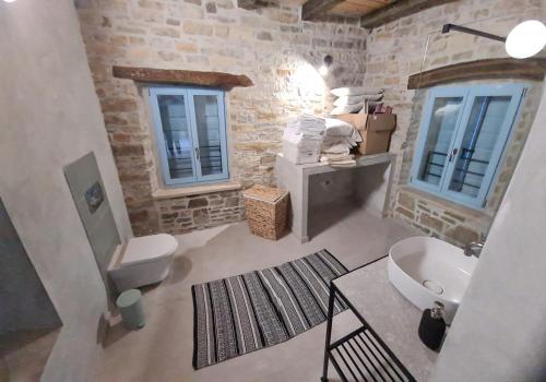 La salle de bains est pourvue d'un lavabo, de toilettes et de fenêtres. dans l'établissement Casa Jovanin, à Livade