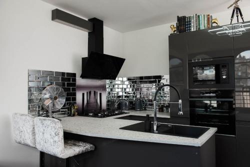 a kitchen with a sink and a stove at The Arches Apartments Kendal in Kendal