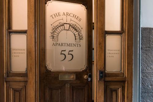 a wooden door with a sign on it at The Arches Apartments Kendal in Kendal