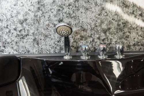 a table with three glasses and a microphone on it at The Arches Apartments Kendal in Kendal