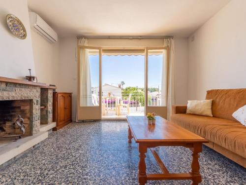 a living room with a couch and a coffee table at Holiday Home Oleg by Interhome in Torredembarra