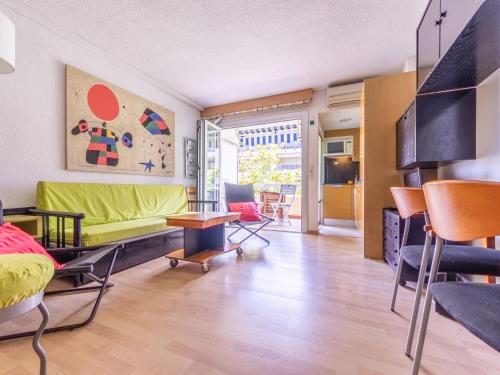 a living room with a green couch and chairs at Studio Alboran by Interhome in Salou