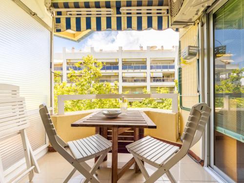 a table and chairs on a balcony with a window at Studio Alboran by Interhome in Salou