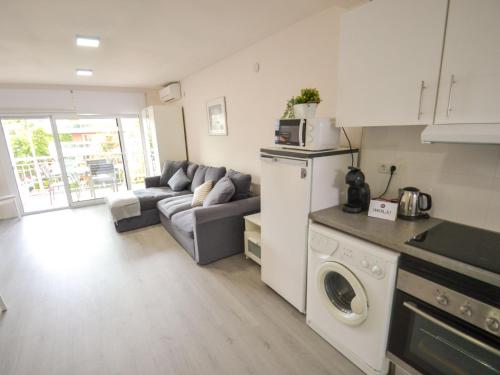a kitchen and living room with a couch and a microwave at Apartment Mare Nostrum by Interhome in Salou