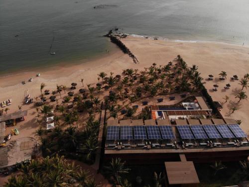 an aerial view of a resort with solar panels on the beach at Movenpick Resort Lamantin Saly in Saly Portudal