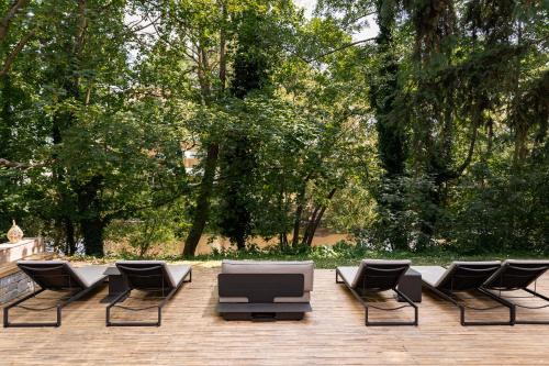 a group of chairs and a couch on a patio at Hôtel Diana Restaurant & Spa by HappyCulture in Molsheim