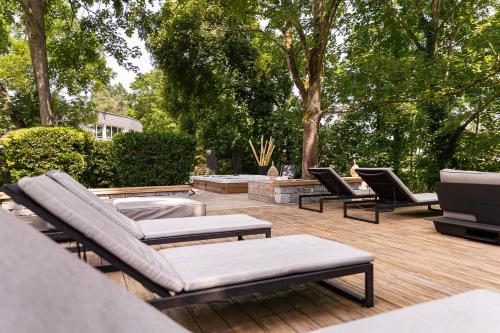 a patio with couches and chairs on a wooden deck at H&ocirc;tel Diana Restaurant & Spa by HappyCulture in Molsheim