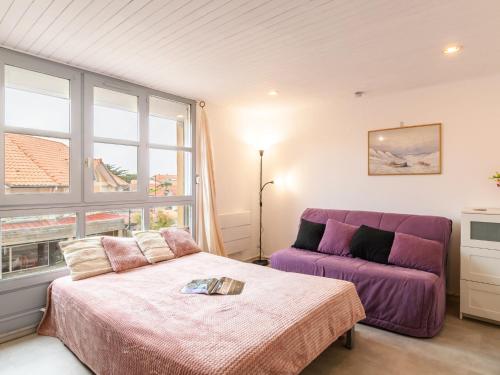 - une chambre avec un lit et un canapé violet dans l'établissement Studio Galerie Casino by Interhome, à Mimizan