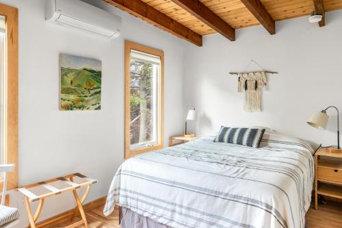 a white bedroom with a bed and a window at Huron Hideaway in Ocean Bay Park