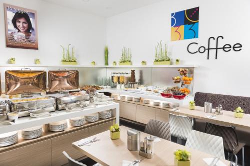 a kitchen filled with lots of different types of food at Bo33 Hotel Family & Suites in Budapest