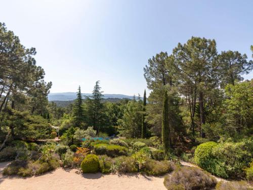 a garden with a view of trees and bushes at Holiday Home La Tourelle des Ocres by Interhome in Roussillon