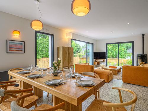a dining room with a wooden table and chairs at Villa Villa Azur by Interhome in Carnac