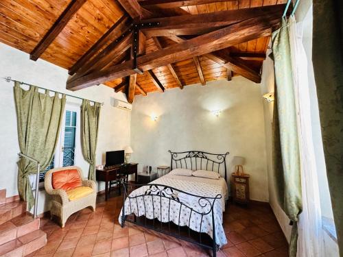 a bedroom with a bed and a chair and a desk at Clementina House in Fiumicino