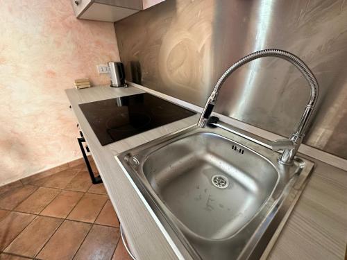 a stainless steel sink in a small kitchen at Clementina House in Fiumicino