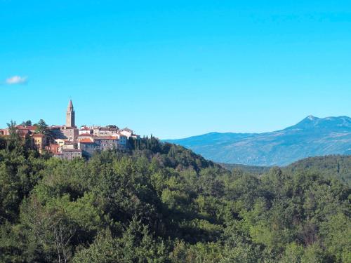 a town on top of a hill in the mountains at Holiday Home Di Nelo by Interhome in Labin