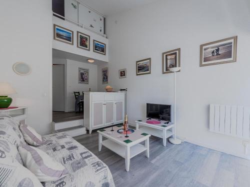 un salon avec un canapé et une table dans l'établissement Apartment du Golf-10 by Interhome, à Saint Cyprien Plage