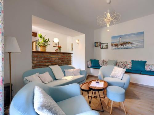 a living room with blue couches and a table at Holiday Home Villa Nicolara by Interhome in Buzet